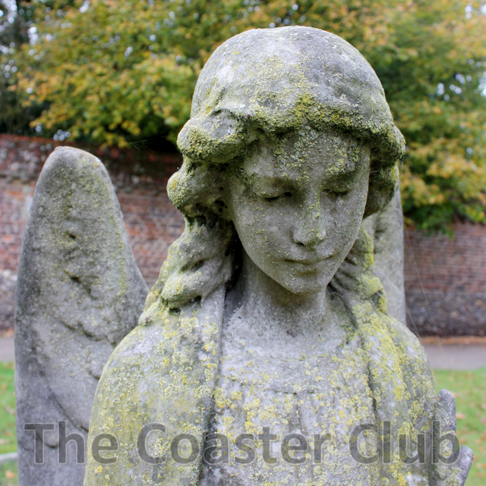 stone carving of a serene angel watching over a grave