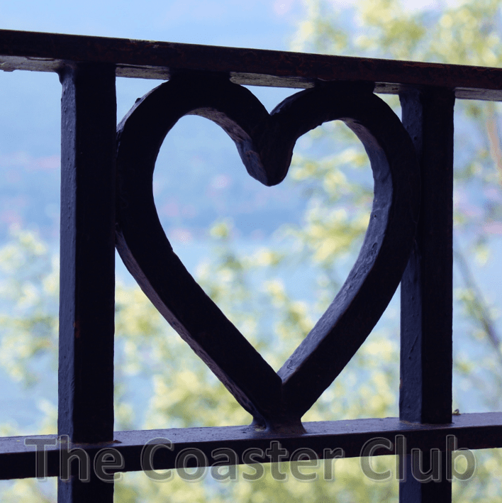 loveheart in metal railings surrounding a romantic lakeside cafe in Italy